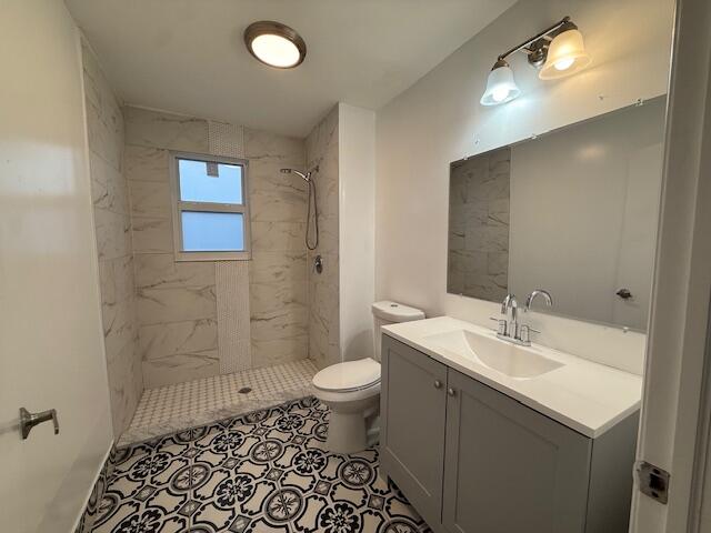 919 2nd Street, Unit 2 West Palm Beach, FL 33401 - Photo 10 of 14 a bathroom with a sink a toilet a shower and a mirror