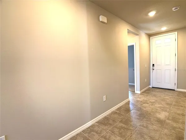 a view of hallway with a bathroom