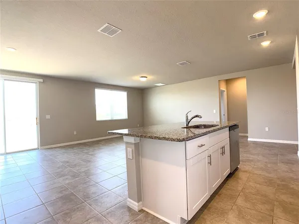 a kitchen with granite countertop a sink and a stove