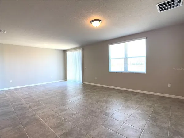 an empty room with windows and entrance