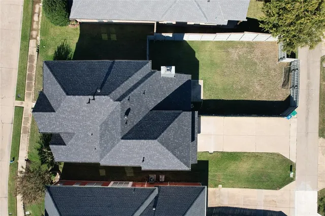 an aerial view of a house with a yard