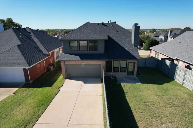 an aerial view of a house with a yard
