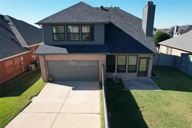 a front view of a house with table and chairs