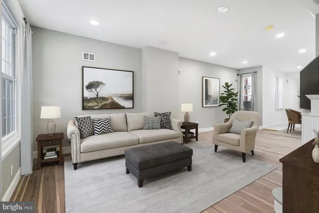 a living room with furniture and a painting