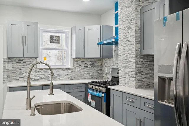 a kitchen with a sink stove and refrigerator