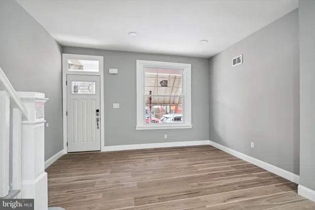 wooden floor in an empty room with a window