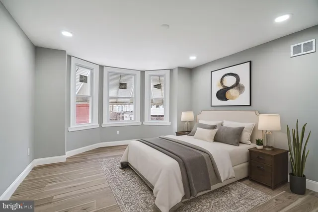 a bedroom with a large bed and a window