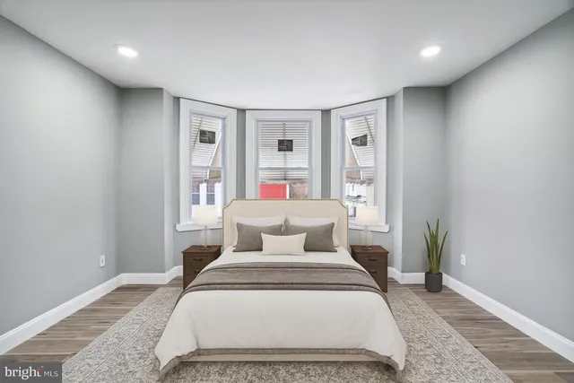 a bedroom with a large bed and a window