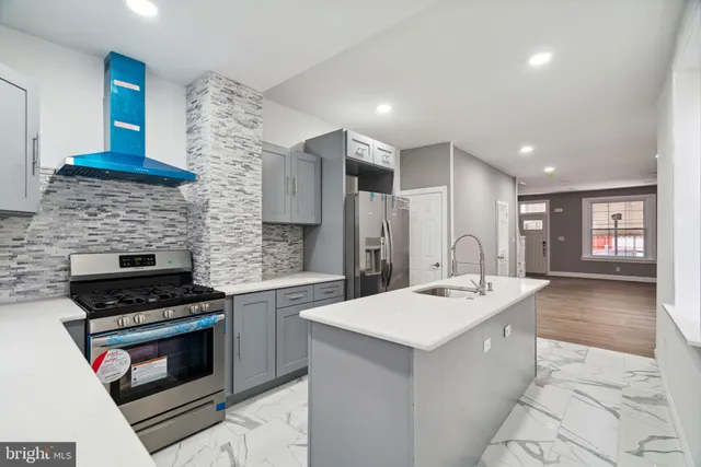 a kitchen with a sink stove and cabinets