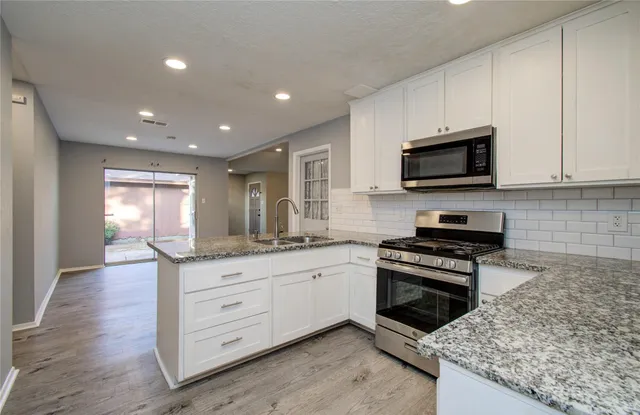 a bathroom with a granite countertop sink and mirror