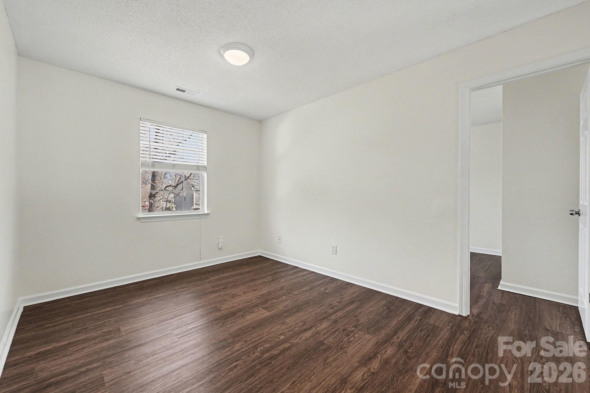 3402 Mayhurst Drive Indian Trail, NC 28079 - Photo 12 of 23 an empty room with wooden floor and windows
