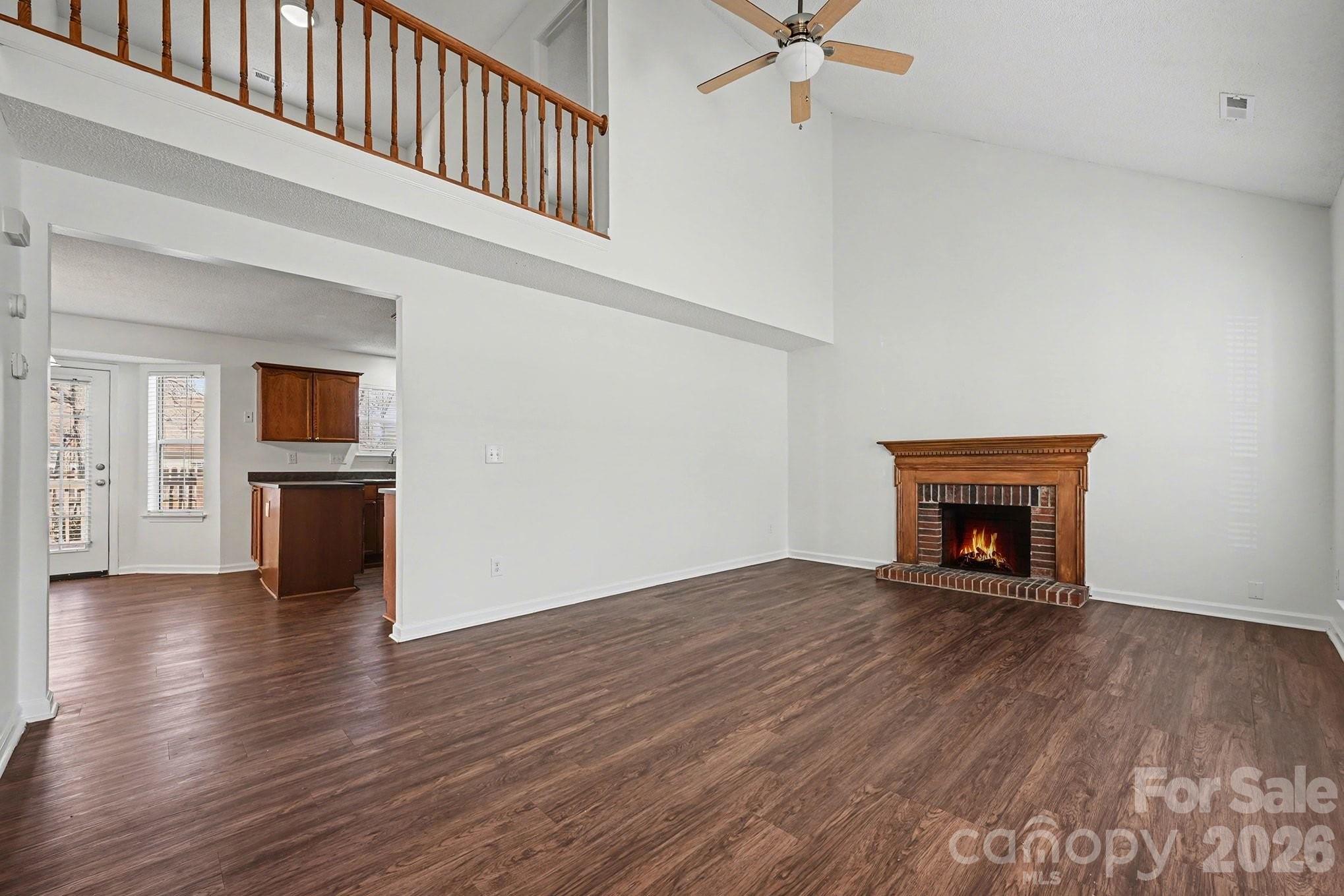 3402 Mayhurst Drive Indian Trail, NC 28079 - Photo 15 of 23 an empty room with wooden floor fireplace and windows