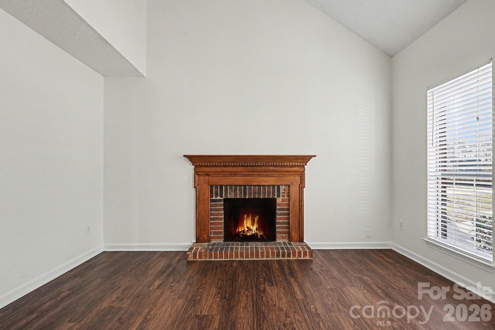 3402 Mayhurst Drive Indian Trail, NC 28079 - Photo 4 of 23 an empty room with wooden floor and fireplace