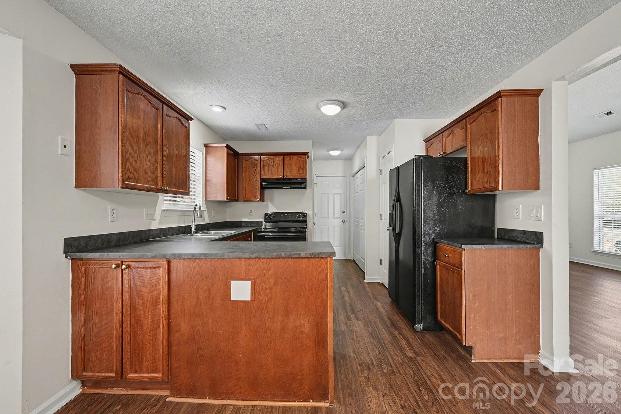 3402 Mayhurst Drive Indian Trail, NC 28079 - Photo 6 of 23 a kitchen with stainless steel appliances granite countertop a refrigerator a stove top oven a sink and dishwasher
