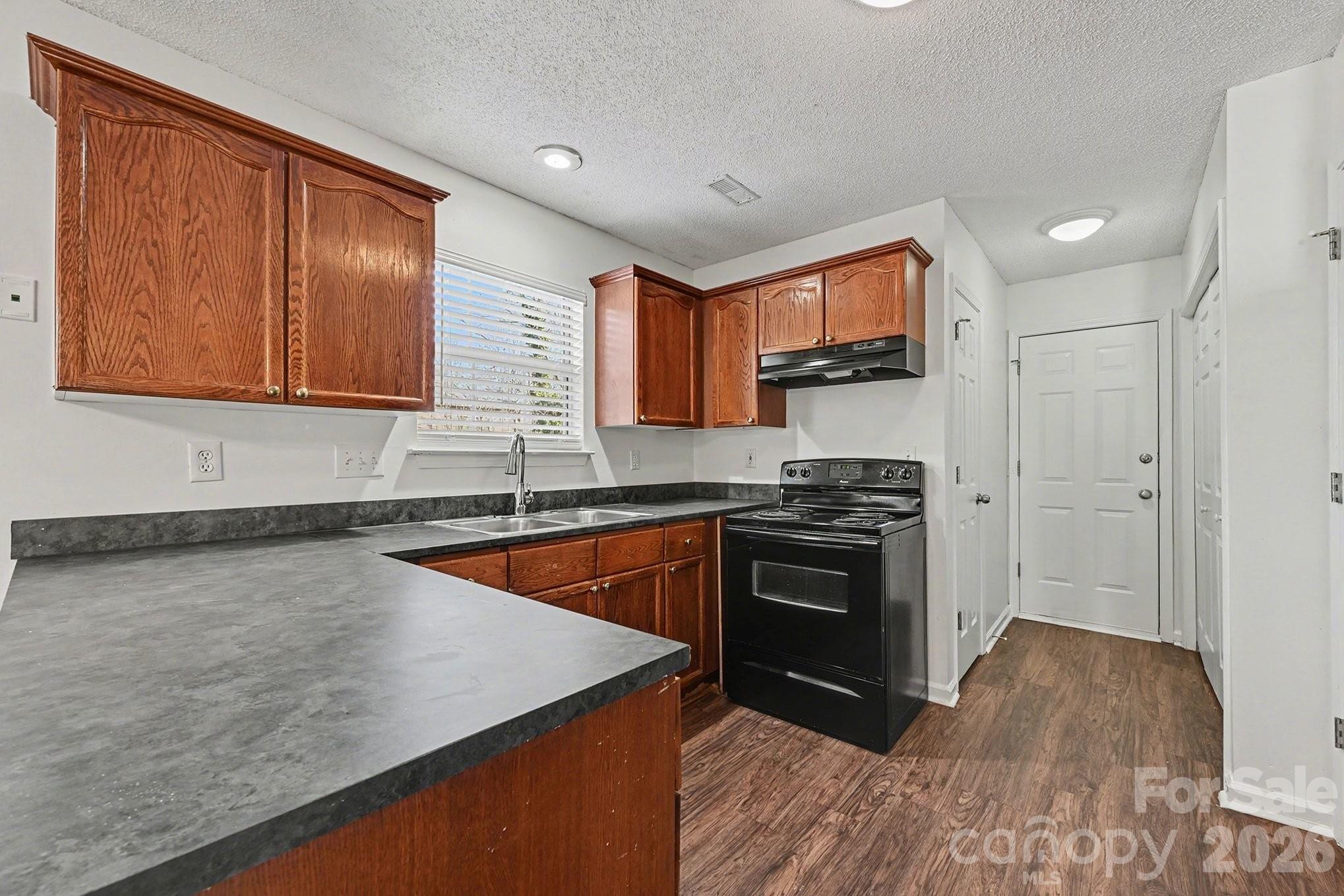 3402 Mayhurst Drive Indian Trail, NC 28079 - Photo 7 of 23 a kitchen with stainless steel appliances granite countertop a stove a sink and a microwave