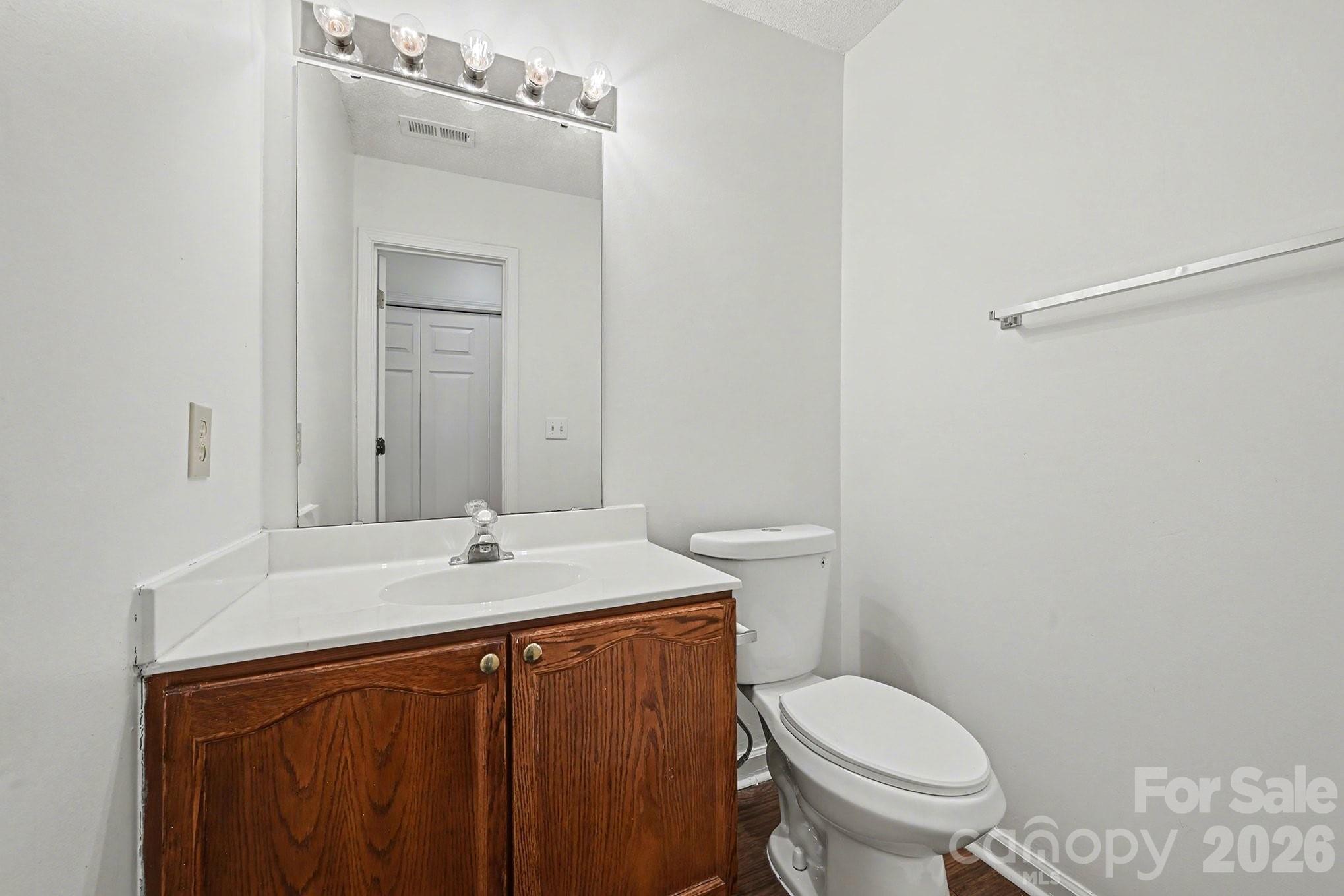 3402 Mayhurst Drive Indian Trail, NC 28079 - Photo 9 of 23 a bathroom with a sink vanity mirror and toilet