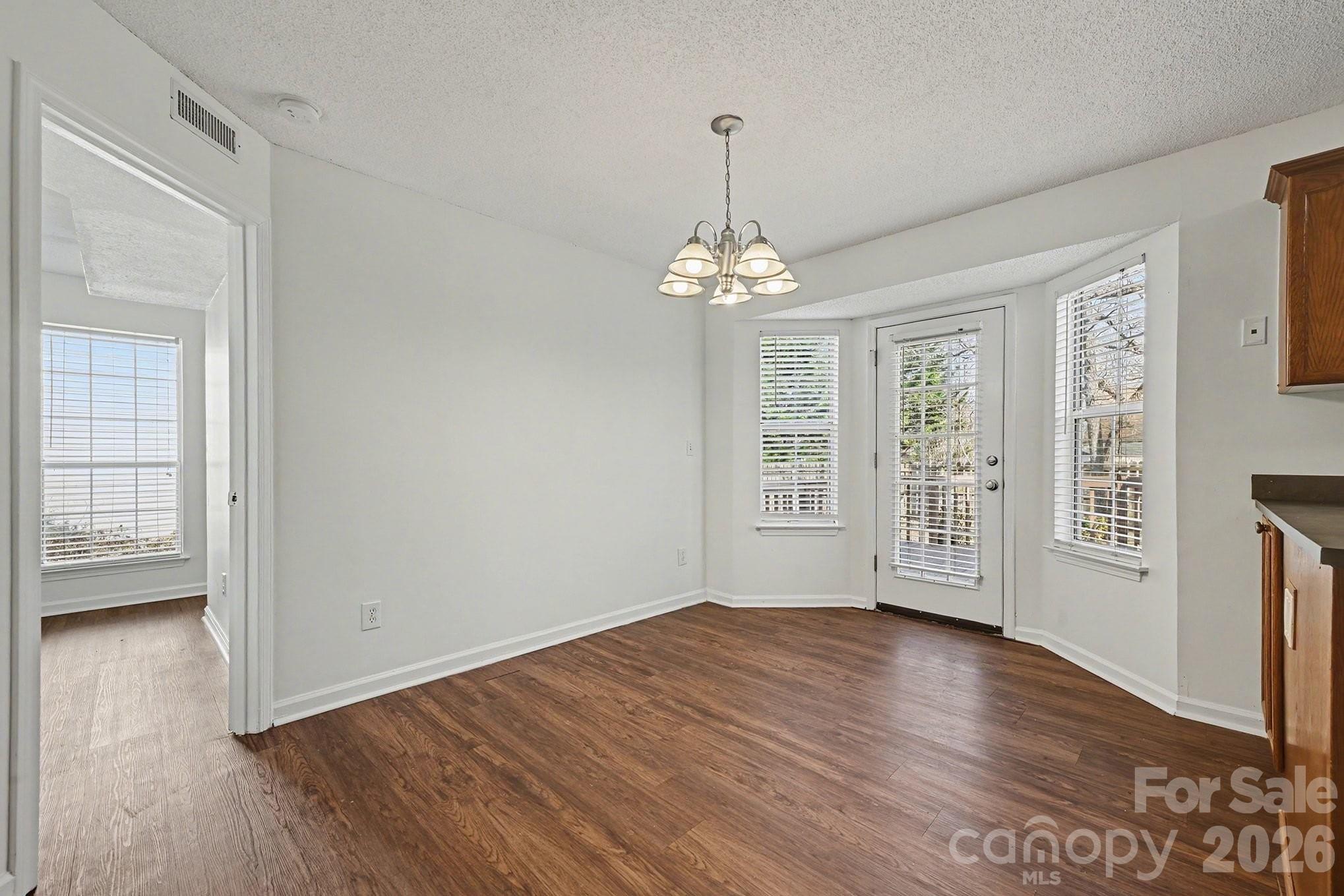 3402 Mayhurst Drive Indian Trail, NC 28079 - Photo 10 of 23 a view of an empty room with wooden floor and a window
