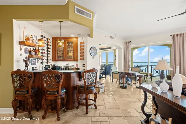 a view of a dining room with furniture and a large window