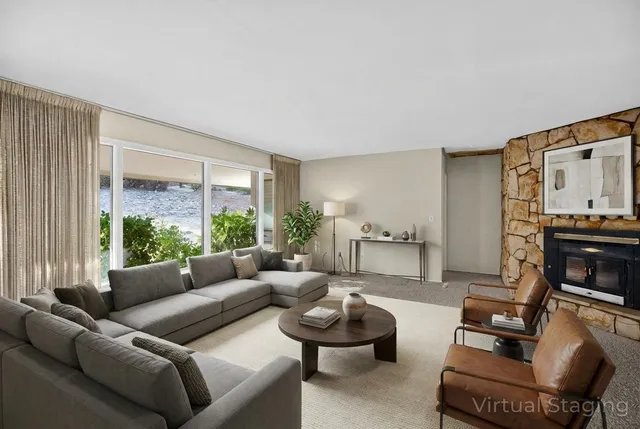 a view of an empty room with fireplace and a window