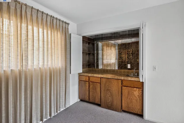 a bedroom with a bed and a chair with the outer view