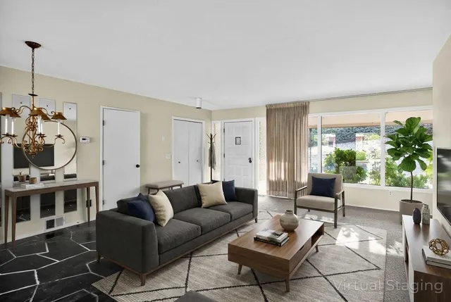 a spacious bedroom with a bed and a chandelier