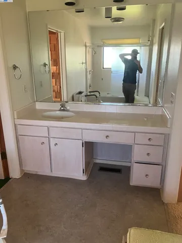 a bathroom with a sink and mirror
