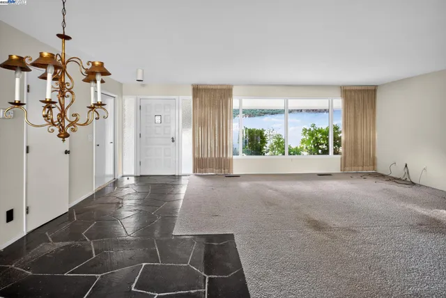 a view of a livingroom with an empty space and a fireplace