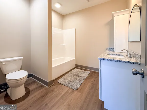 a bathroom with a toilet sink and a mirror