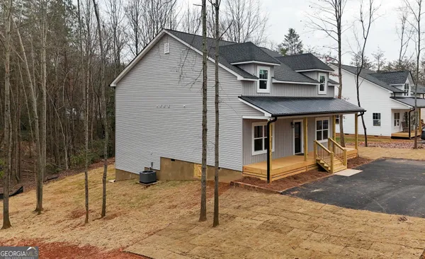 a front view of a house with a garden