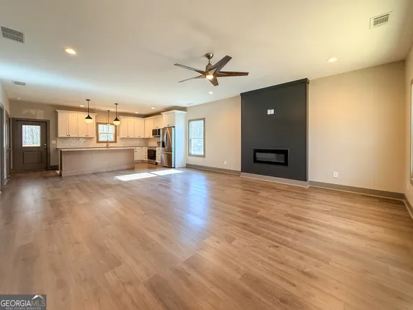 a view of a kitchen with a sink and a fireplace