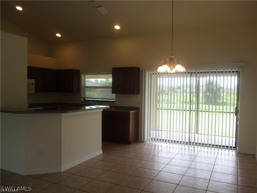 520 Raintree Street East Lehigh Acres, FL 33974 - Photo 11 of 18 a kitchen with stainless steel appliances a stove and a refrigerator