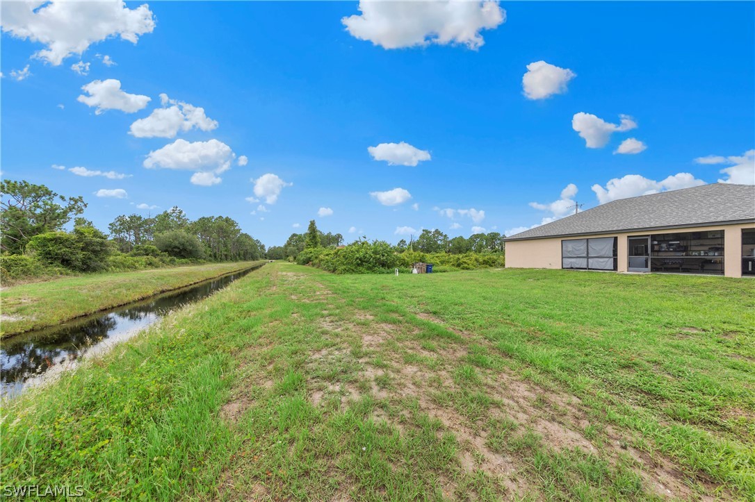 520 Raintree Street East Lehigh Acres, FL 33974 - Photo 7 of 18 a view of a house with yard and a garden