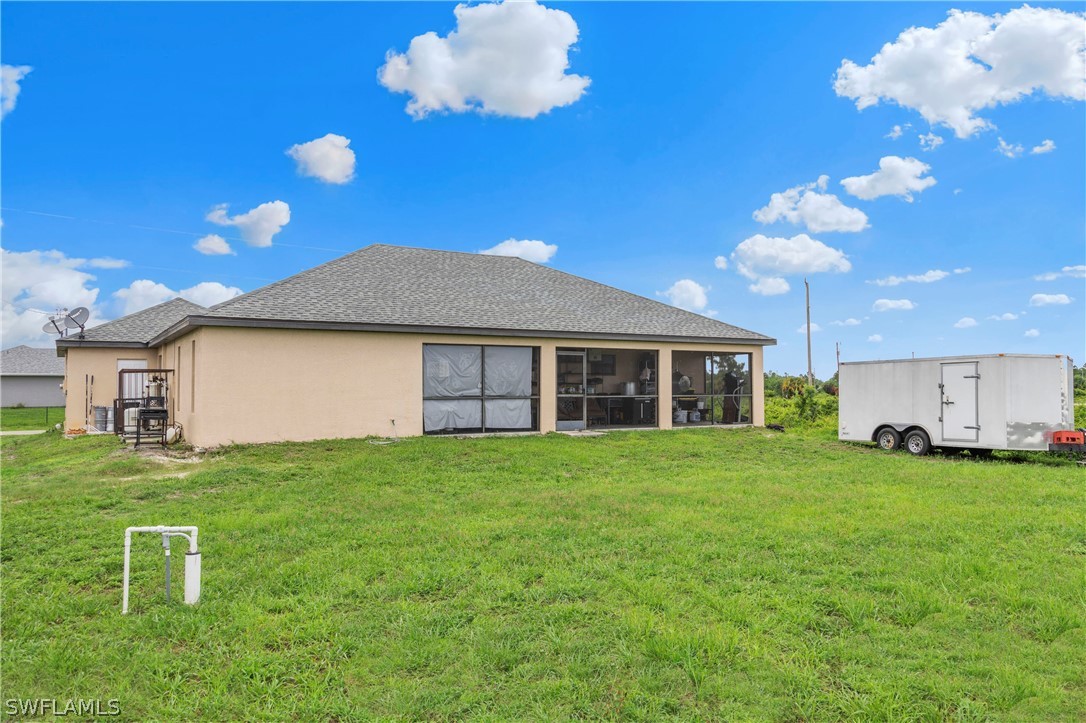 520 Raintree Street East Lehigh Acres, FL 33974 - Photo 9 of 18 a view of a house with a backyard