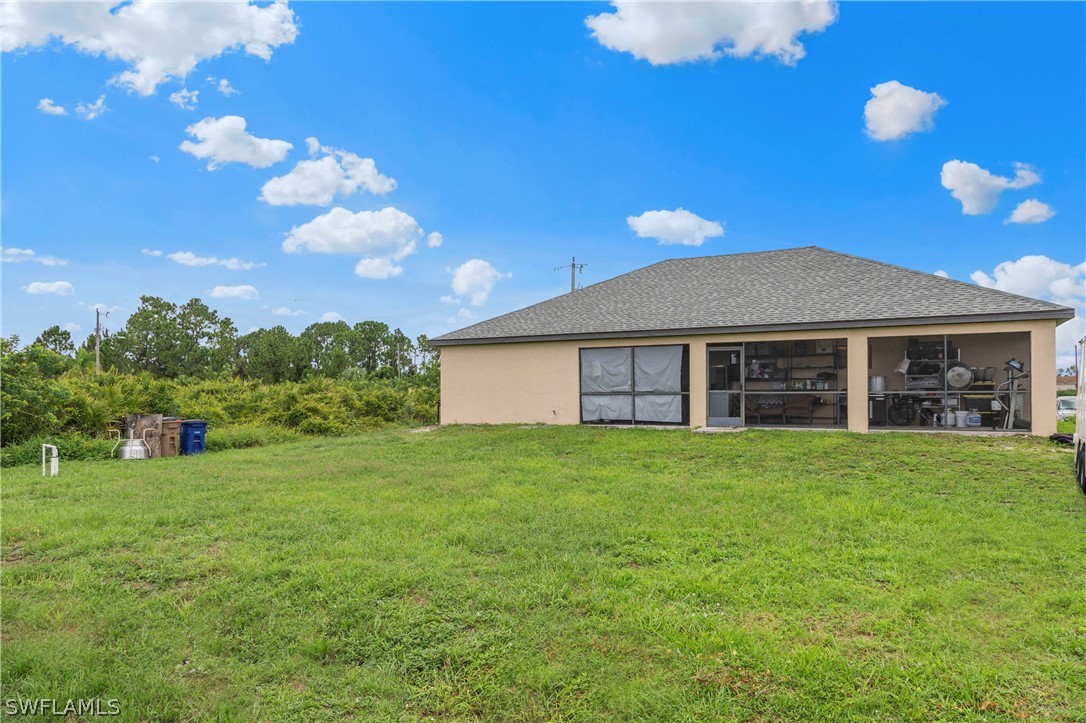 520 Raintree Street East Lehigh Acres, FL 33974 - Photo 10 of 18 a view of a house with a backyard