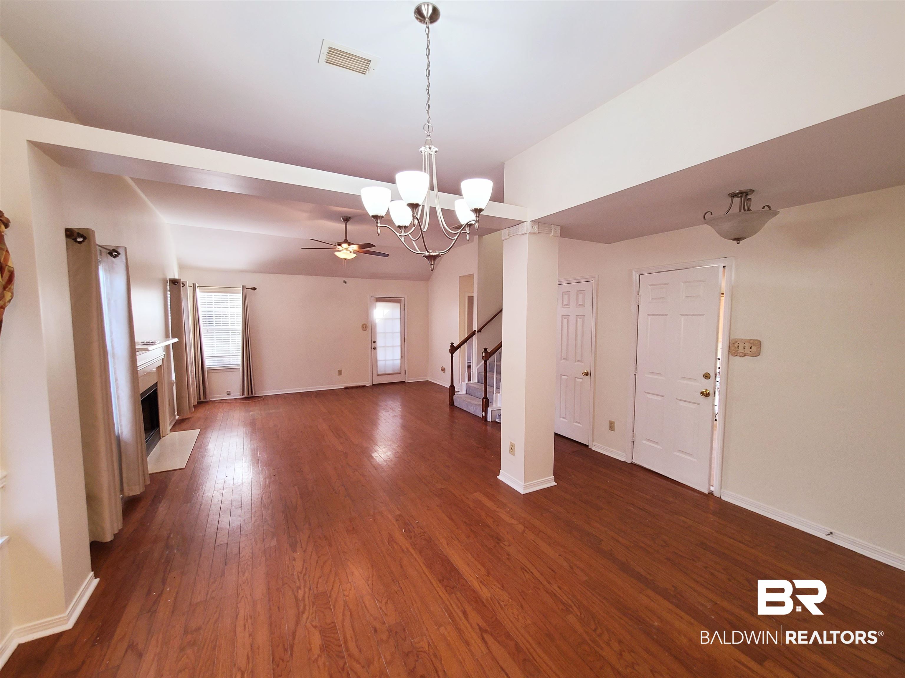 123 Melanie Loop Daphne, AL 36526 - Photo 4 of 17 Unfurnished living room with dark wood-style floors, suspended lighting, a fireplace with flush hearth, and a ceiling fan
