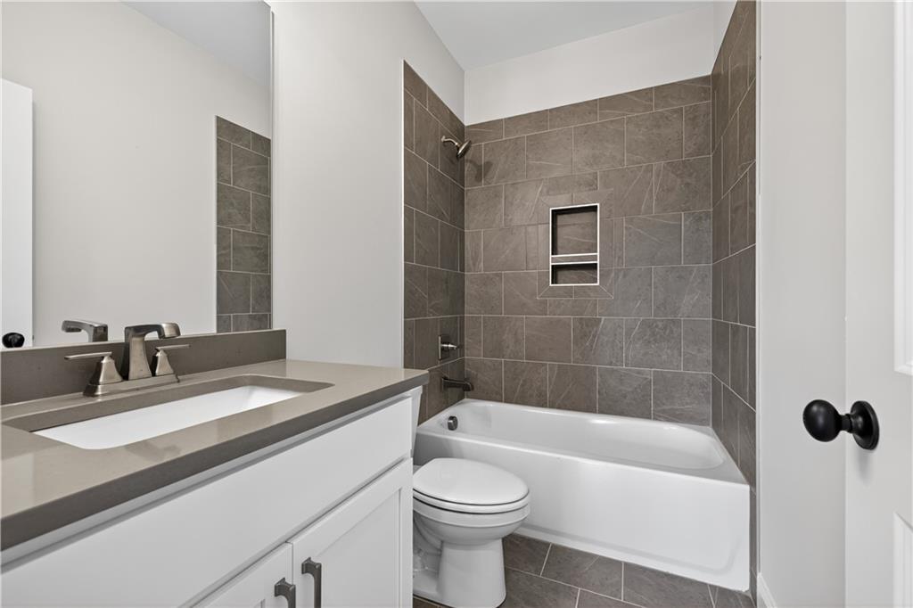3787 Cheyenne Lane Jefferson, GA 30549 - Photo 34 of 82 a bathroom with a granite countertop bathtub sink vanity mirror and toilet