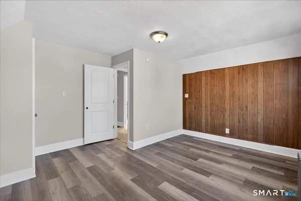 a view of an empty room with wooden floor