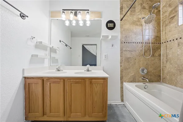 a bathroom with a tub sink and mirror