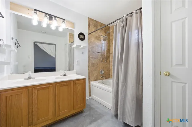 a bathroom with a double vanity sink mirror and shower