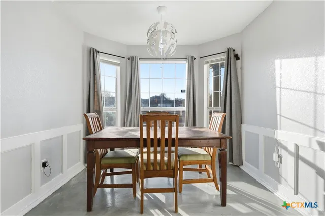 a view of a dining room with furniture window and outside view