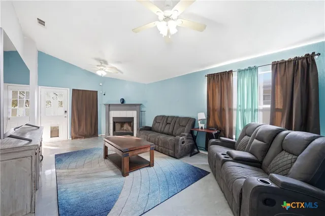 a living room with furniture fireplace and flat screen tv