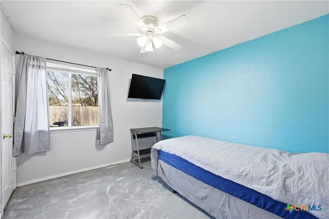 a bedroom with a bed and a flat screen tv