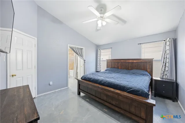 a bedroom with a bed and a couch