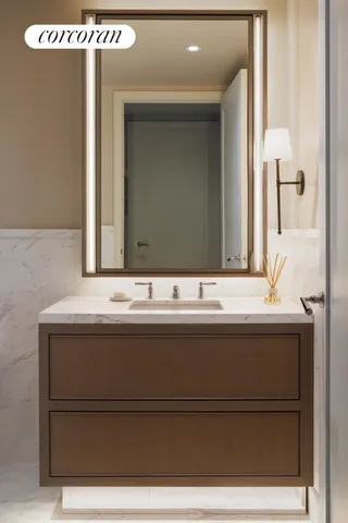 a bathroom with a sink a toilet and mirror
