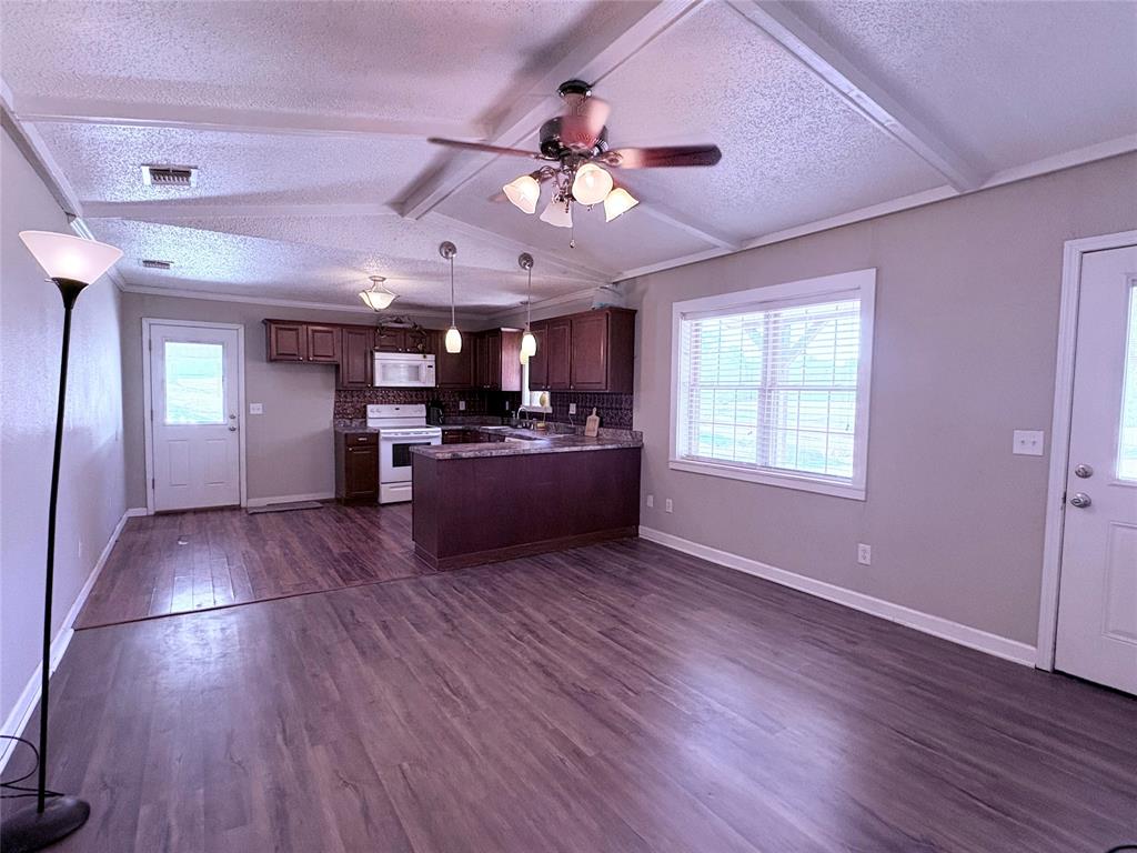 768 Highway 507 Castor, LA 71016 - Photo 11 of 22 a living room with hard wood floors and a kitchen