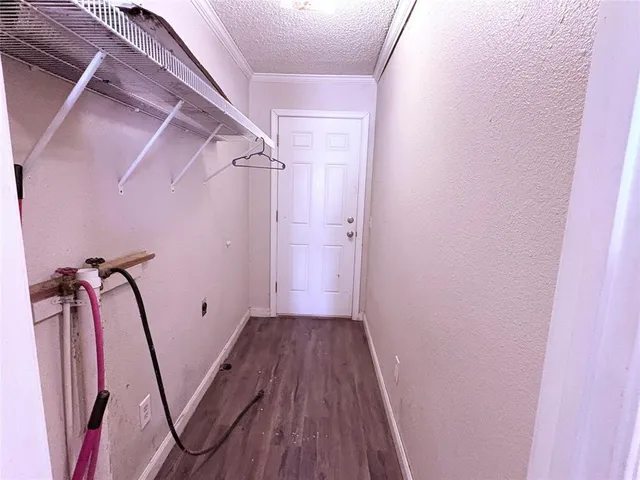 a view of a room with wooden floor and white walls