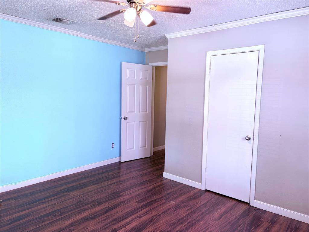 768 Highway 507 Castor, LA 71016 - Photo 19 of 22 an empty room with wooden floor and fan