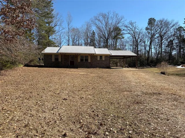 a front view of house with yard and trees