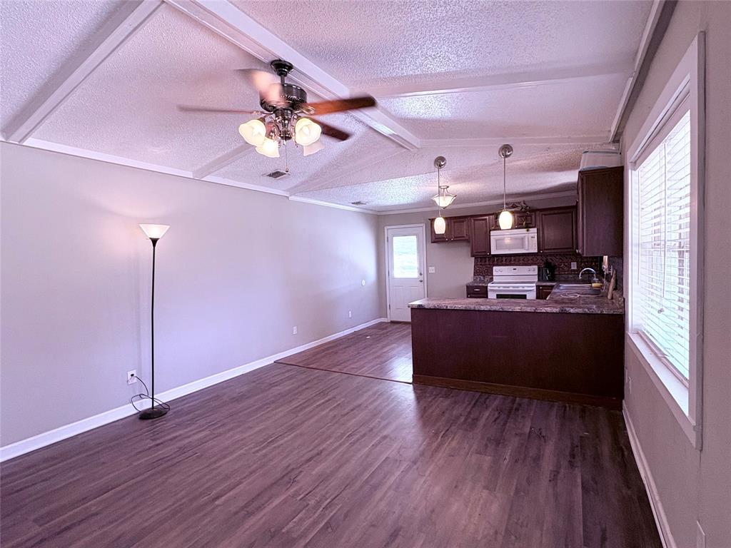 768 Highway 507 Castor, LA 71016 - Photo 10 of 22 a living room with stainless steel appliances kitchen island granite countertop wooden floors a stove and a microwave