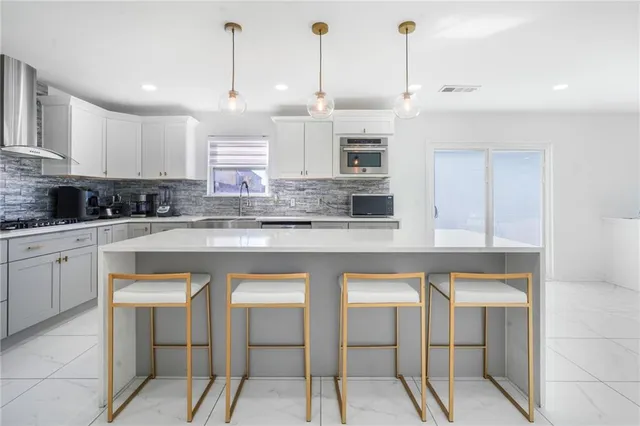 a kitchen with stainless steel appliances granite countertop a sink and cabinets